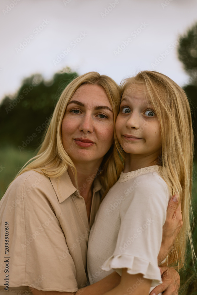 Fototapeta premium Mother and daughter share a tender moment with a playful expression