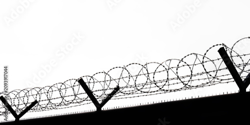  metal grid fence with barbed wire against sky Border of runway Barbed wire drawn in circles isolated on white background