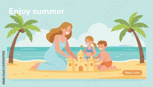 Loving mother builds a beautiful sandcastle with her two happy children on a sunny tropical beach by the ocean.