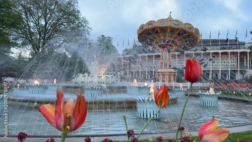 Fountain and carousel at Tivoli Gardens amusement park, Copenhagen, Denmark