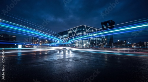 Bild auf Leinwand Traffic Light Trails Past a Modern Building at Night