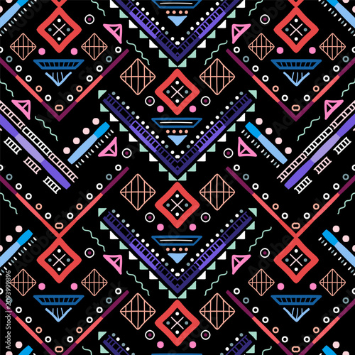 Zigzag tribal chevron seamless pattern. African, Aztec. Geometric vector oriental background. Multicolor backdrop with triangles, dots, and diamonds. Mayan Lines, stripes.
