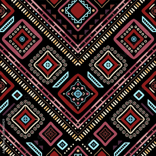 Zigzag tribal chevron seamless pattern. African, Aztec. Geometric vector oriental background. Multicolor backdrop with triangles, dots, and diamonds. Mayan Lines, stripes.