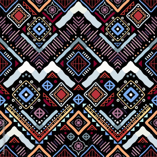 Zigzag tribal chevron seamless pattern. African, Aztec. Geometric vector oriental background. Multicolor backdrop with triangles, dots, and diamonds. Mayan Lines, stripes.