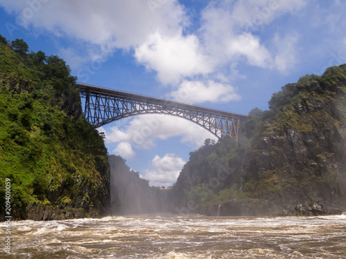 фотографія High bridge over rapidly flowing river gorge on sunny day