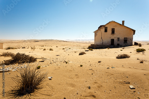 Canvastavla Barren desert surrounds abandoned house in old ghost town settlement in Africa