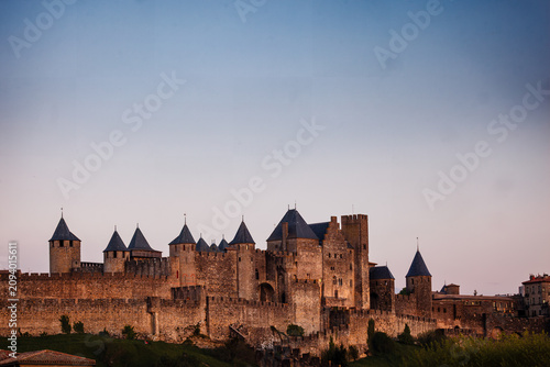 Bild auf Leinwand Sunrise illuminates the ramparts and towers of the medieval fortress in Carcassonne