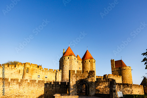 Obraz na płótnie Chateau Comtal towers with sun on their red tile roofs