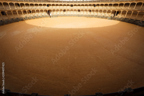 Foto Aerial view of bull fighting ring from top of arena with sun casting circle of s
