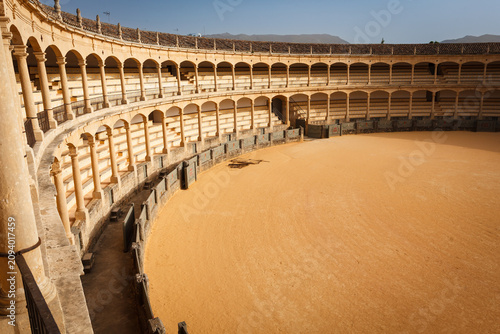 Canvastavla Interior view from the top of the sunlit side of the empty bullfight arena in Ro