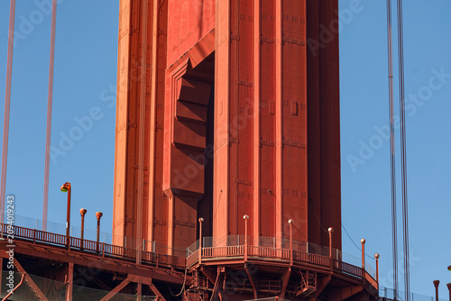 Architectural detail view of Golden Gate Bridge tower’s art deco style, international orange color, and many rivets