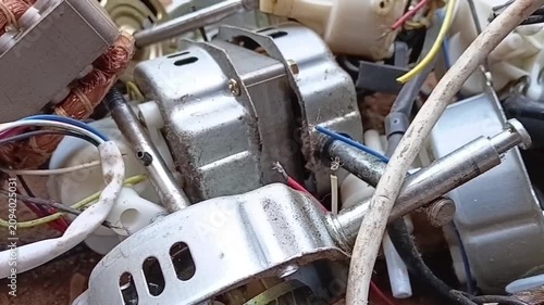 Panning Left Over Discarded Fan Motor Waste and Scrap Electric Motors. Accumulation of E-Waste Awaiting Manual Dismantling and Copper Recovery