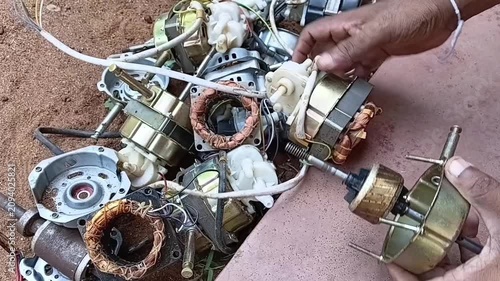 Disassembling Discarded Fan Motor and Separating Metal Parts. Manual E-Dismantling and Scrap Motor Disassembly for Copper and Iron Recovery