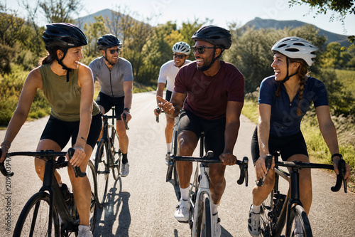 Group of Cyclists Riding on Road - Community, Team Sport & Outdoor Activity