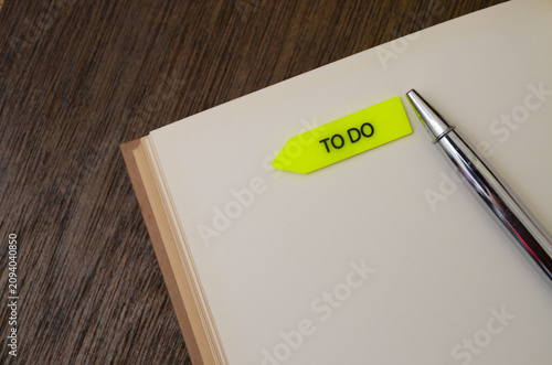 Open Blank Notebook with Pen and To Do Sticky Note Arrow for Planning