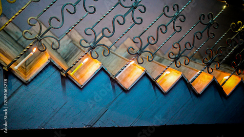 A candle placed on the steps of the staircase.