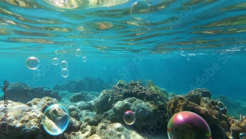 Iridescent soap bubbles over coral reef underwater