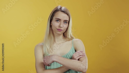 A Fashionable Young Woman Posing Against a Bright Yellow Background, Radiating Style and Confidence