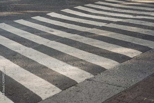Konstfotografi Zebra crossing stripes painted on an asphalt city street for pedestrian safety and traffic regulation