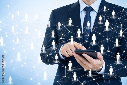 Businessman in suit using smartphone with digital social network interface overlay