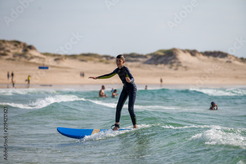Fotografie A child practising surf in Portugal;