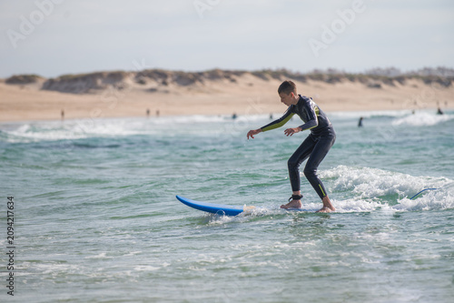 Obraz na płótnie A child practising surf in Portugal;