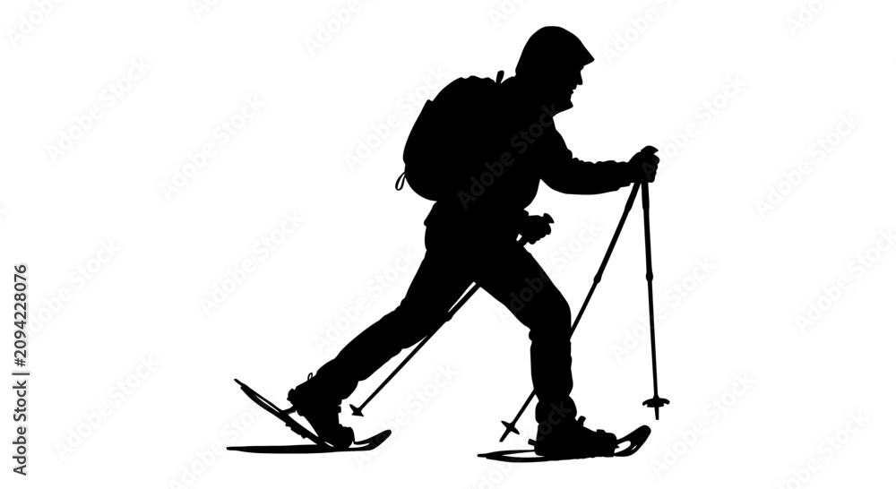 Fototapeta premium Silhouette of a man hiking with snowshoes.