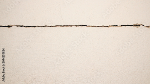 Hairline Crack on White Wall Surface in Residential Interior