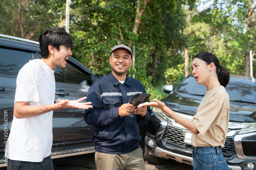 A car insurance agent mediates a heated dispute between two drivers at the scene of an accident.