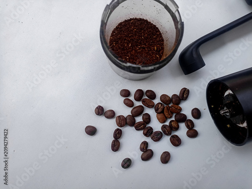 Coffee Grinder with Roasted Coffee Beans and Ground Coffee on White Background