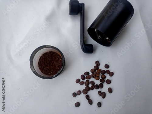 Coffee Grinder with Roasted Coffee Beans and Ground Coffee on White Background