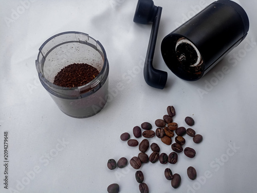 Coffee Grinder with Roasted Coffee Beans and Ground Coffee on White Background