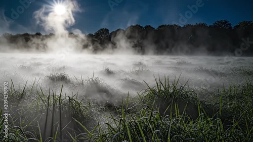 Morning Mist Over a Lake with Rising Sun