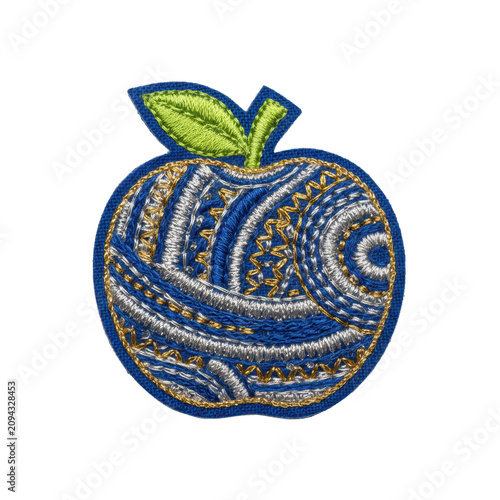 Royal blue apple-shaped fabric patch with metallic accents and a lime-green leaf on a white background, meticulous handicraft concept