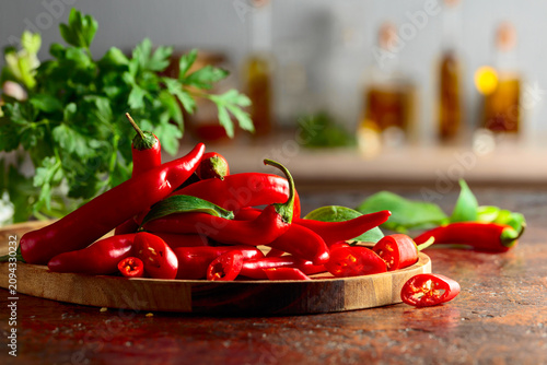 Heap of red hot chili peppers on a kitchen table.