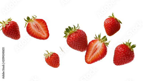 Foto Isolated fresh ripe red strawberries falling through air with whole and juicy ha