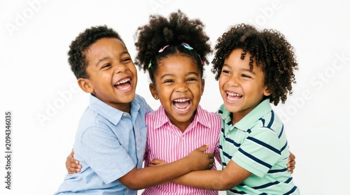 Group of Three Happy African American Children Laughing and Hugging Each Other with Joy, Expressing Genuine Friendship and Childhood Happiness on White Background