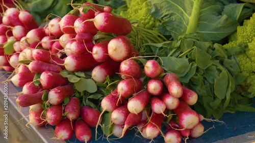 Fresh radishes displayed at farmers market stall