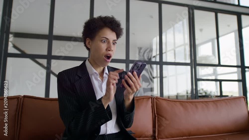Businesswoman Celebrates Surprising Job Offer on Smartphone