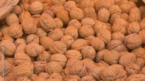 Pile of whole walnuts at market stall