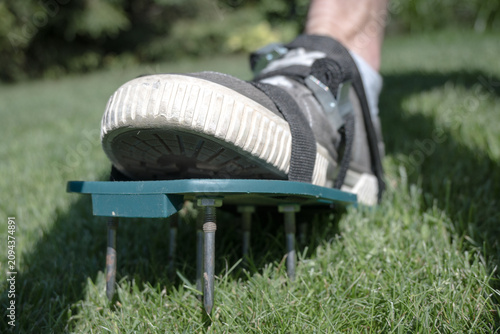 Fotografie Lawn aeration using shoe attachments.