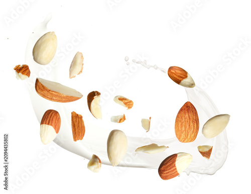 Canvastavla Nut milk splash with almonds in air on transparent background