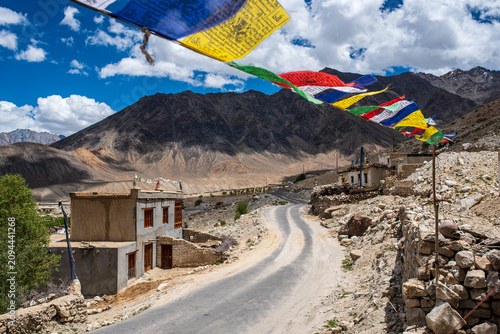 Photos Rural road with traditional houses and prayer flags in a Ladakh village