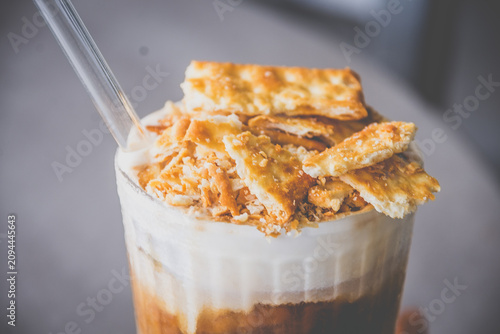 espresso with luscious cream and crushed biscuits scattered across the surface