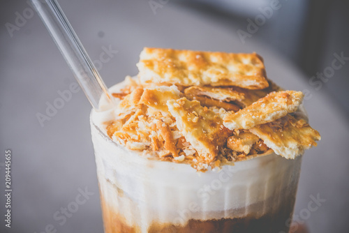espresso with luscious cream and crushed biscuits scattered across the surface
