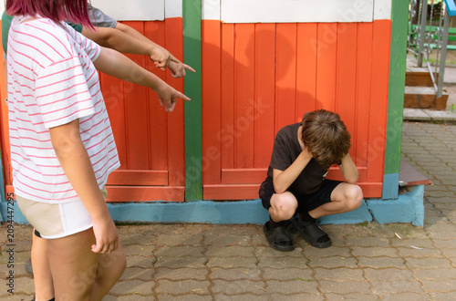 The children are teasing a boy