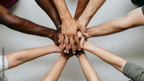 Group of people joining hands in unity circle
