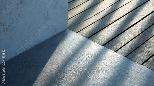 Minimalist architectural detail featuring textured plaster wall concrete floor and wooden deck planks with dramatic sunlight and shadow patterns in modern patio design