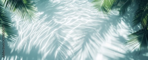 sunlit turquoise water with gentle ripples and overlapping palm leaf shadows creating a peaceful relaxed tropical atmosphere