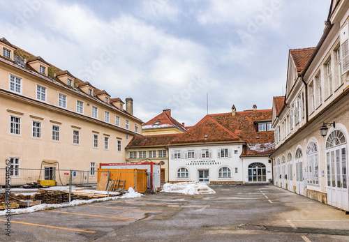 The historic courtyard of the Grazer Burg (Graz Castle) complex under renovation and the Steiermarkische Landesdruckerei building in the old town of Graz.